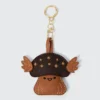 Cute mushroom keychain with star details and wings, perfect for accessorizing bags and keys.