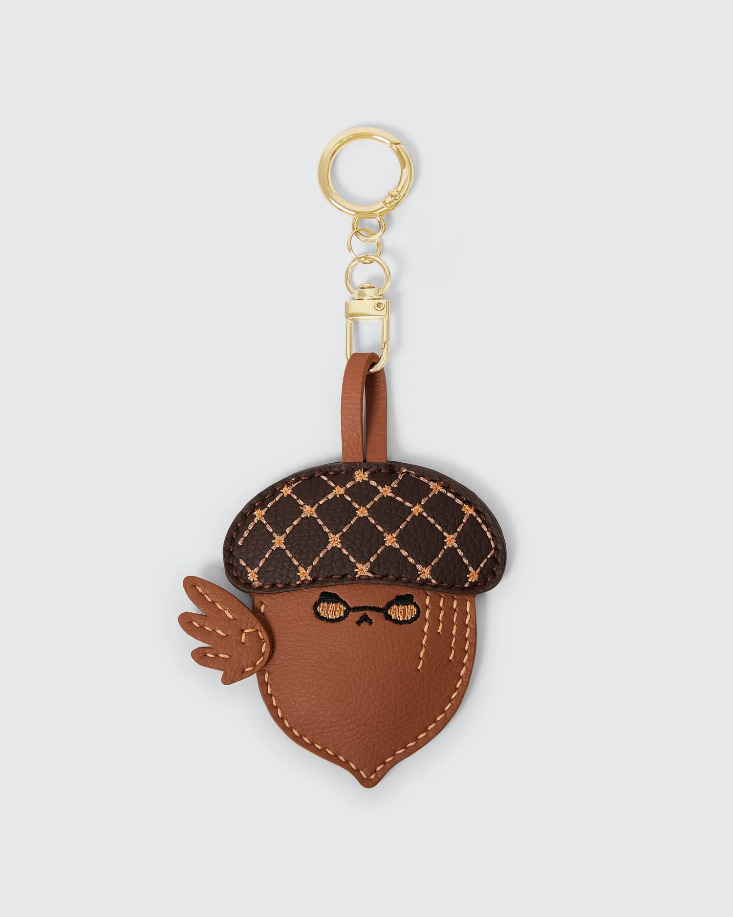 Cute acorn-shaped vegan leather keychain with stitched details and a gold ring, perfect for accessories and gifts.