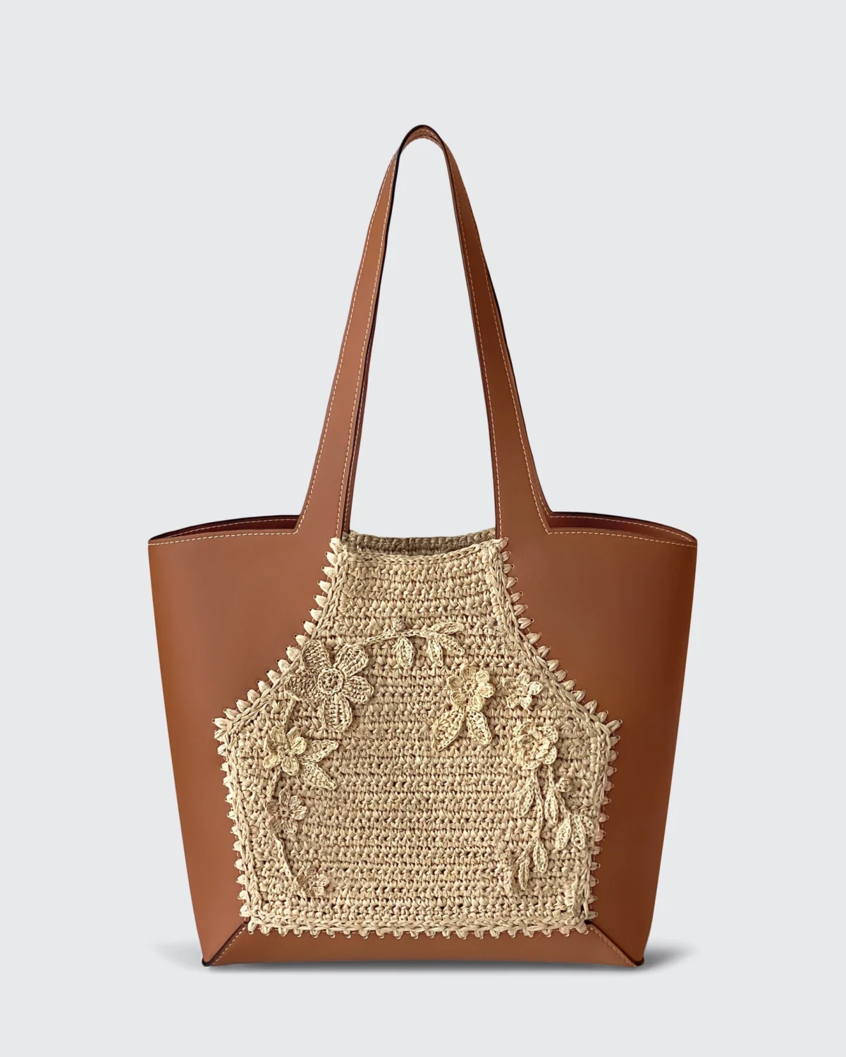 Brown vegan leather ROSIE HONG tote bag with intricate woven floral design, perfect for stylish everyday use.