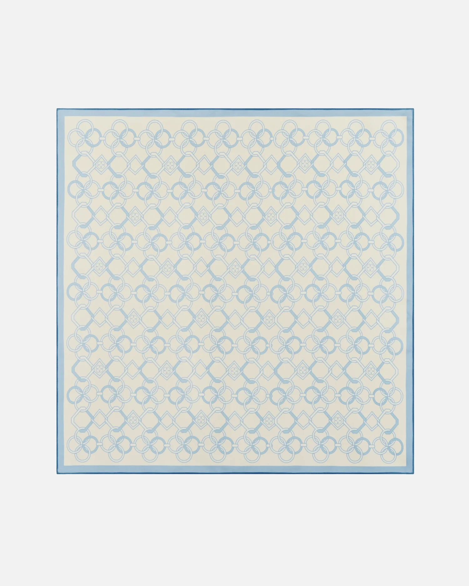 Geometric blue patterned silk scarf with intricate floral and diamond design on a light background.