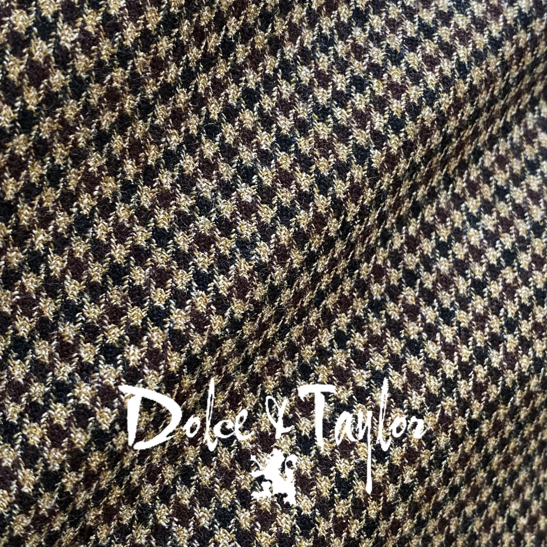 Brown and black houndstooth fabric texture with Dolce & Taylor branding overlay.