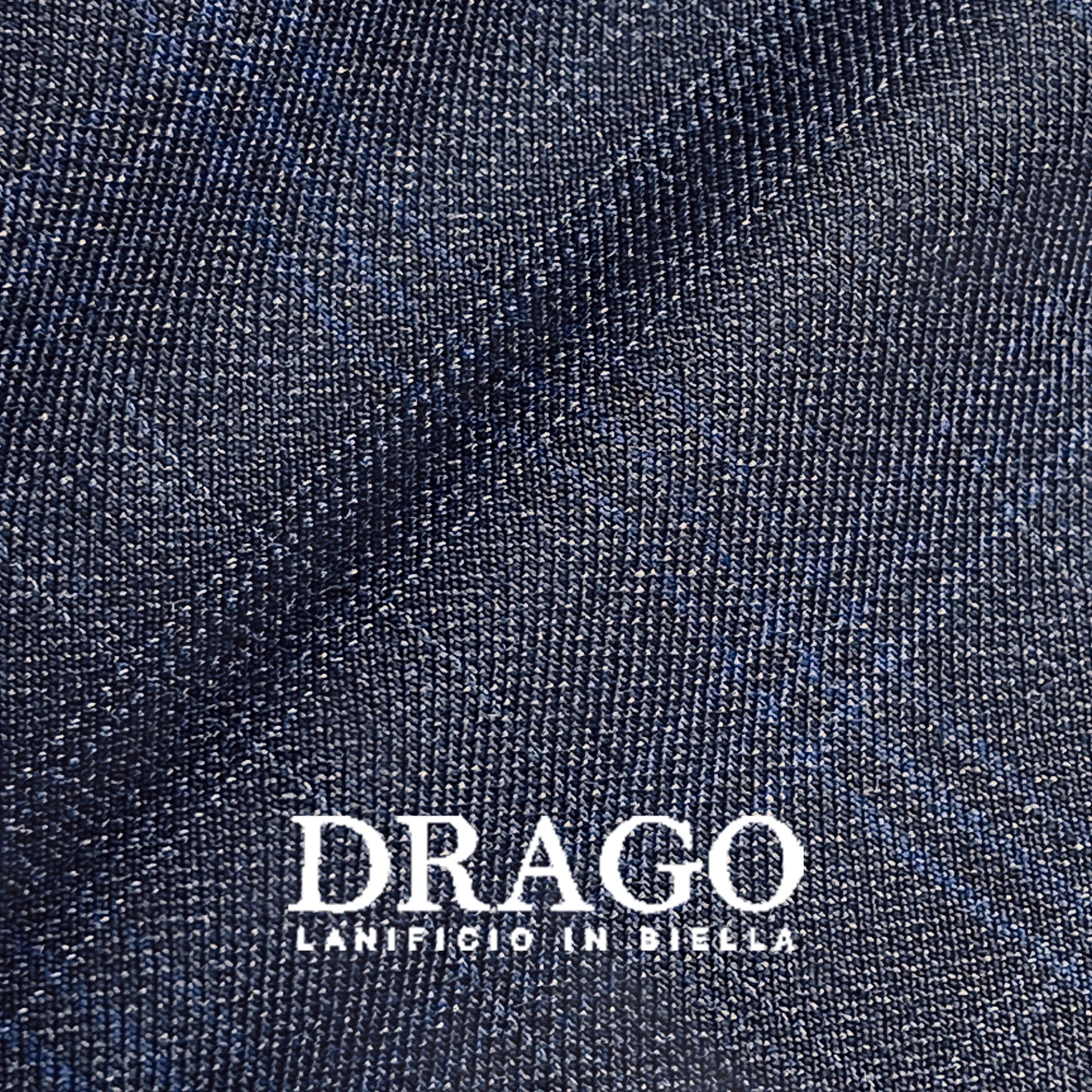 Dark navy fabric texture with diagonal pattern by Drago, Lanificio in Biella, showcasing textile detail and quality.