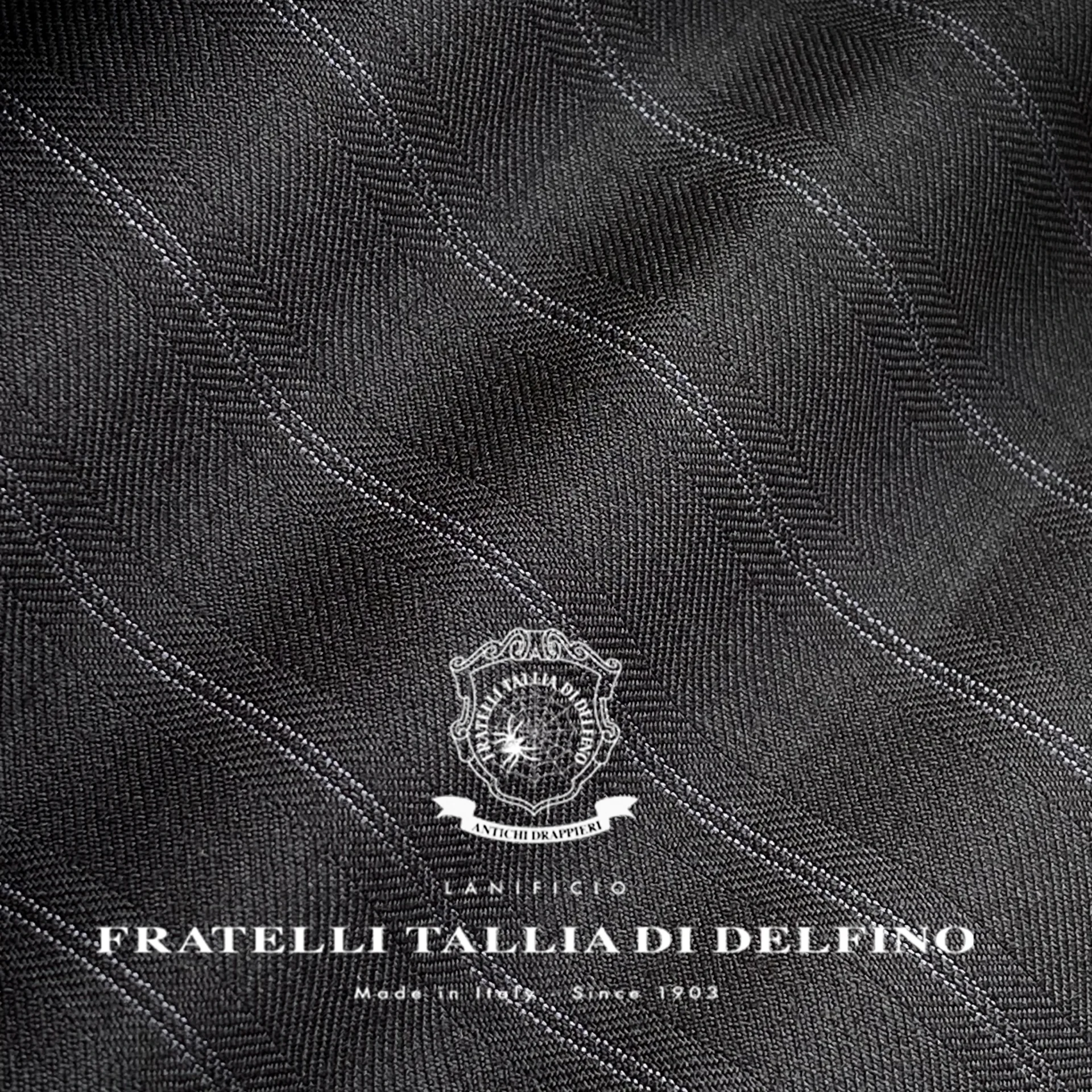 Elegant gray fabric texture from Fratelli Tallia di Delfino, showcasing fine craftsmanship. Made in Italy since 1903.