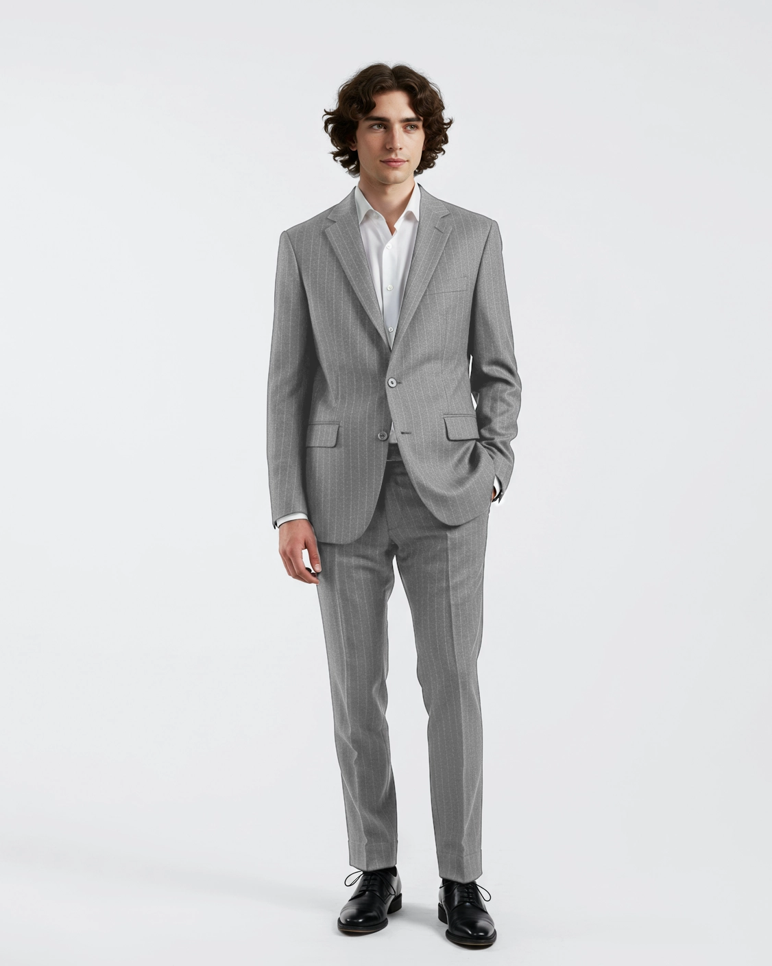 Man in a tailored gray suit with white shirt, standing against a plain background.