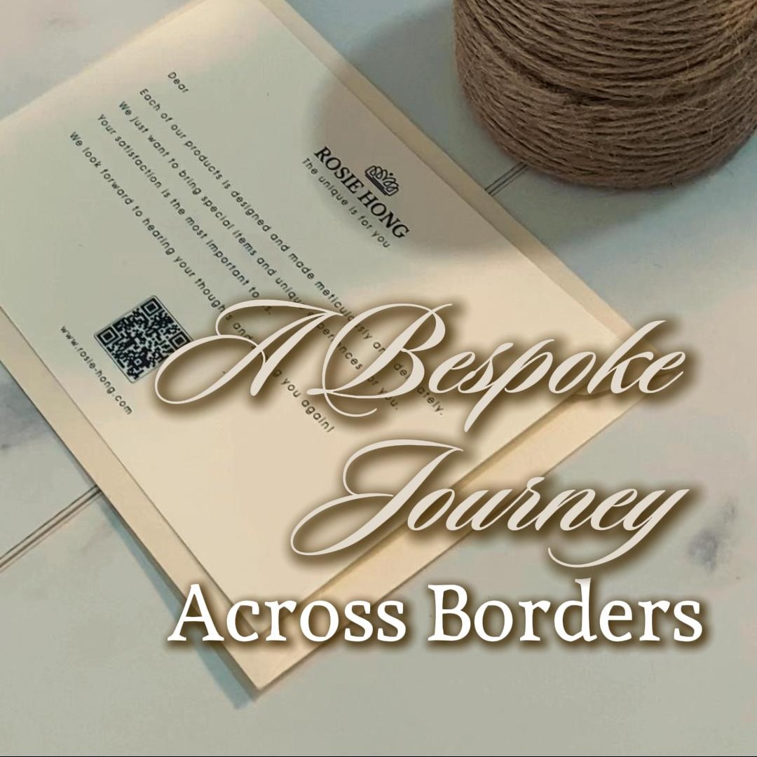 Luxury card with A Bespoke Journey Across Borders text, alongside a spool of thread on a marble surface.