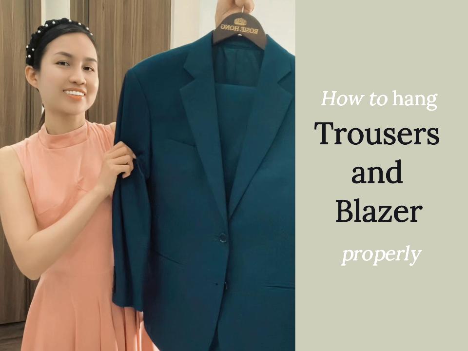 Woman demonstrating how to hang a blue blazer correctly for optimal care and storage.