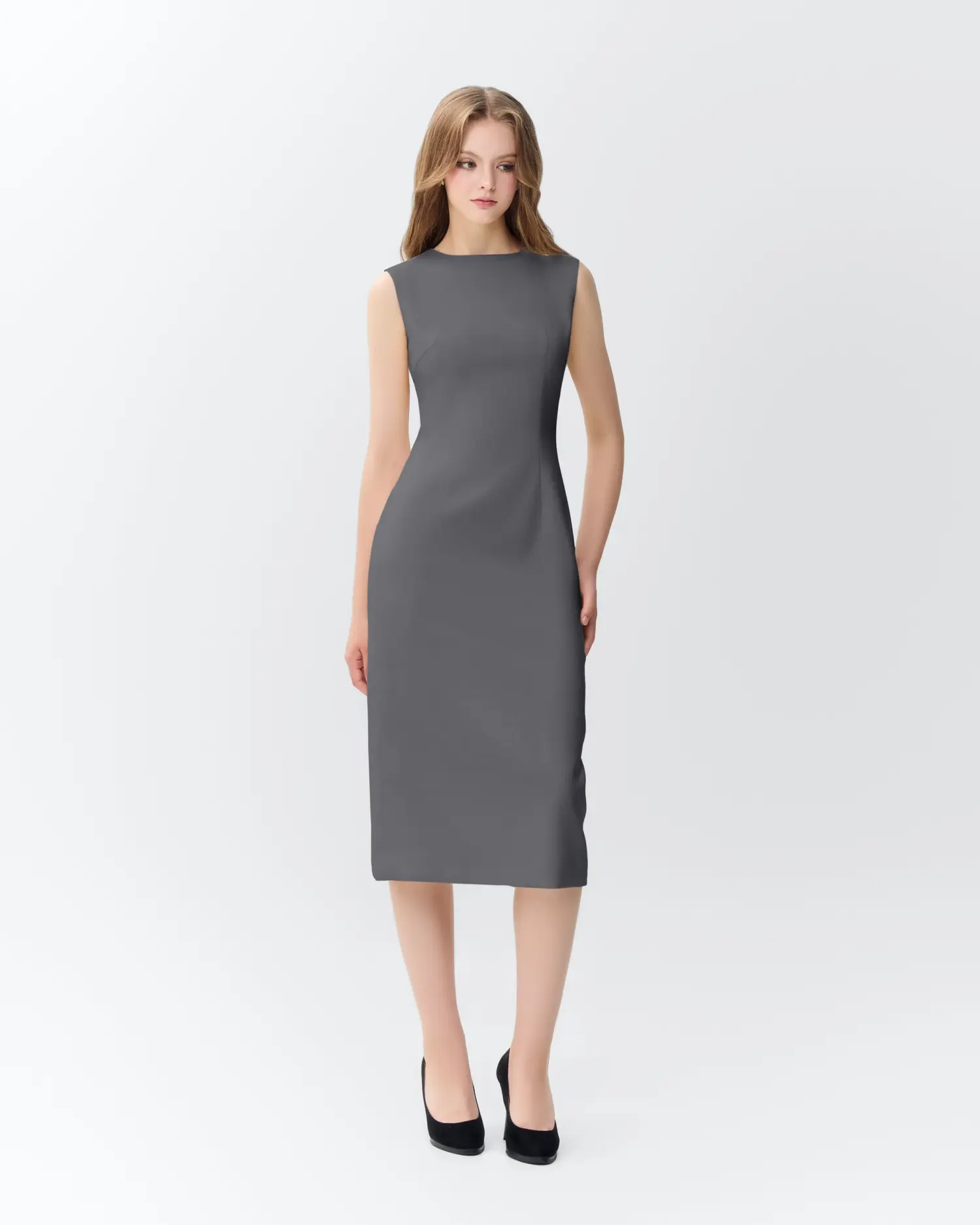 Young woman wearing a sleek gray sleeveless dress with black heels on a white background.