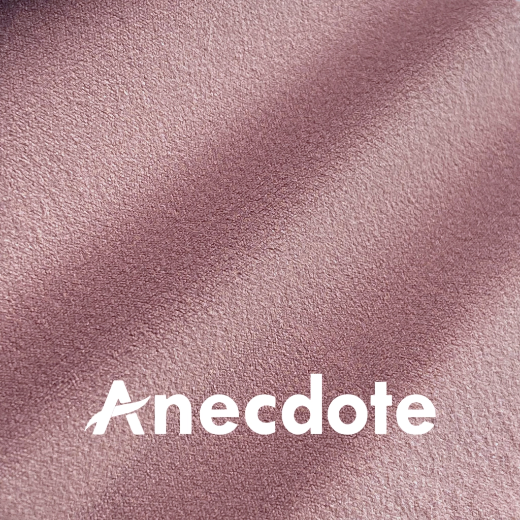 Soft pink textured fabric background with Anecdote text overlay.