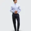 Man in formal attire wearing a light blue shirt and navy pants, standing confidently against a neutral background.