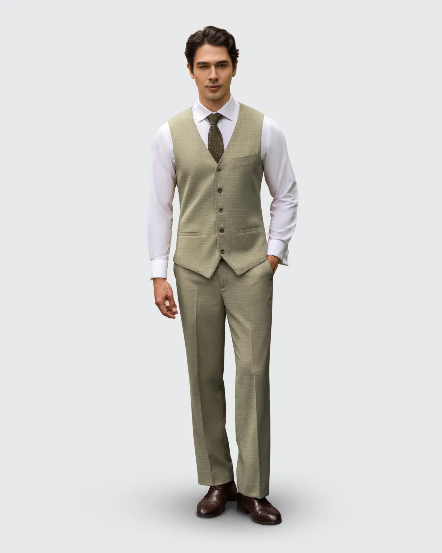 Man in light brown vest and pants, white shirt, and tie, showcasing stylish formal attire.