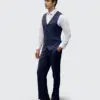 Man in stylish navy suit vest and trousers on a light grey background. Fashionable formal wear for special occasions.
