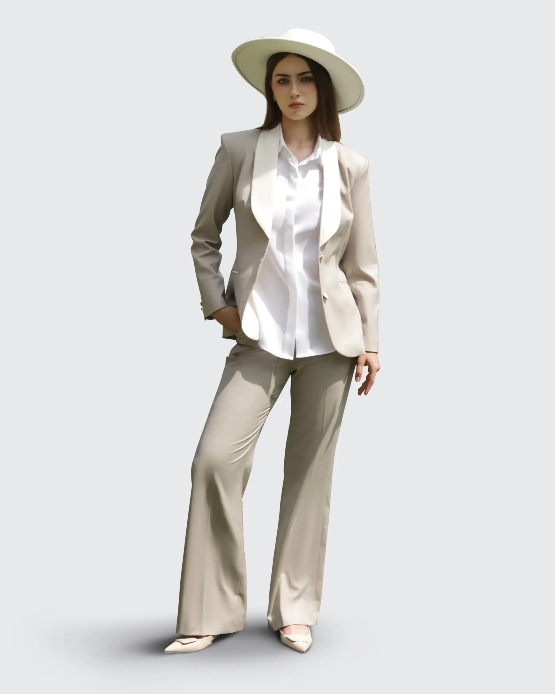 Woman in beige suit and white hat exudes modern elegance and style.