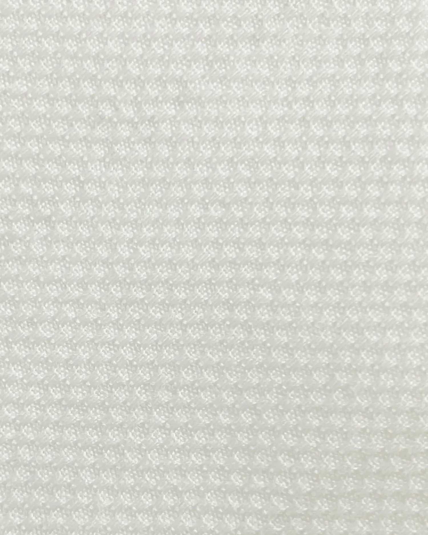 Close-up of textured white fabric pattern, showing detailed weave for material design or textile industry concept.