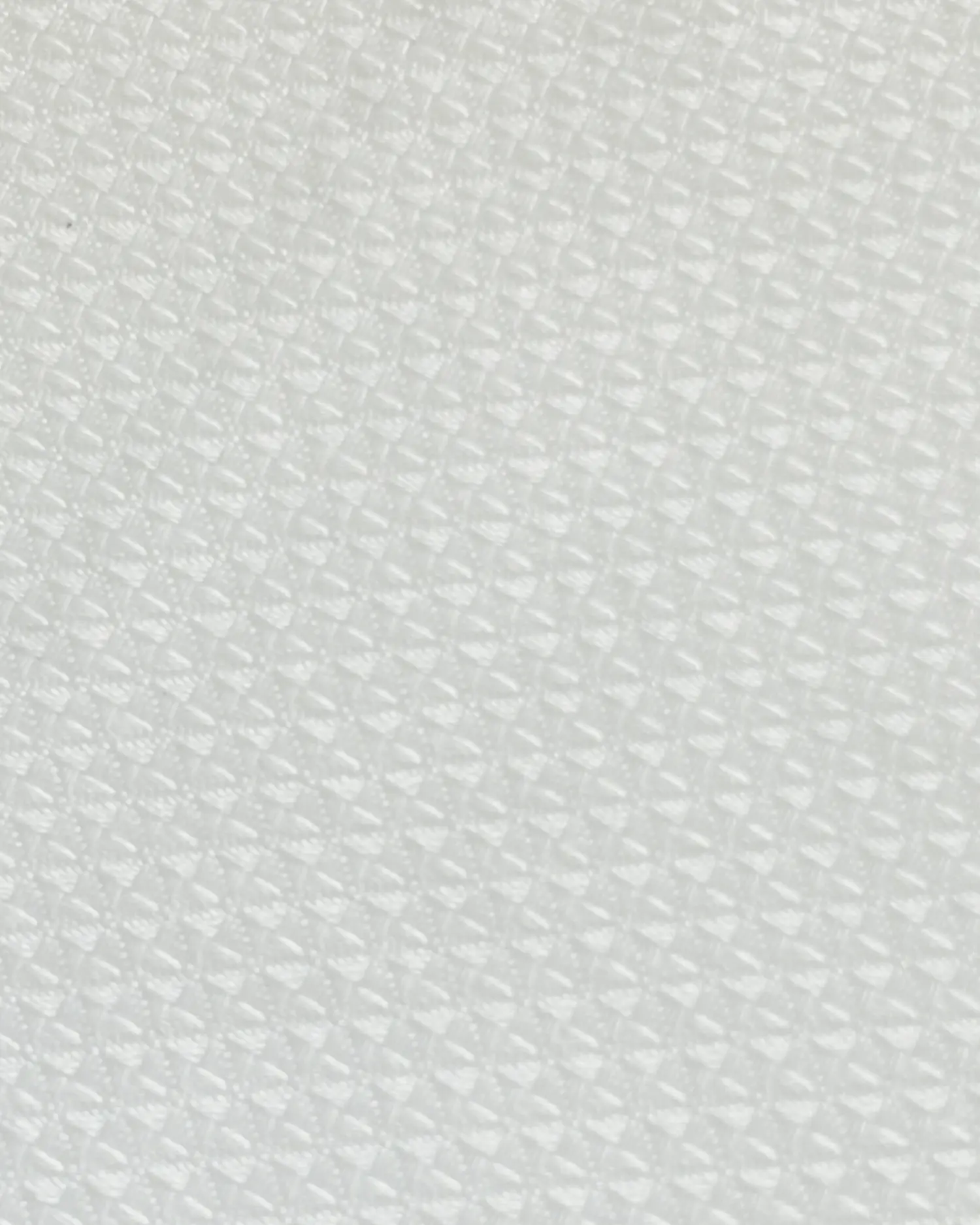 Close-up of textured white surface with small diamond pattern, ideal for background or detail-oriented designs.