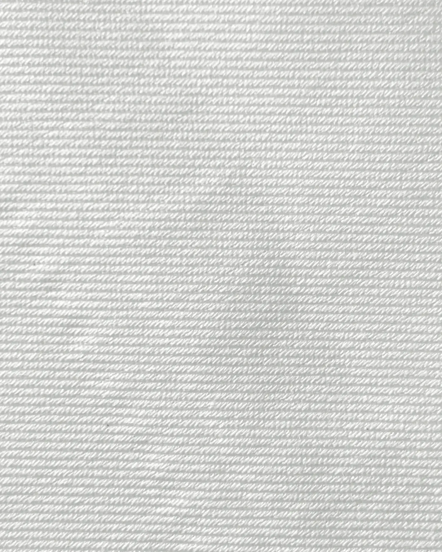 Close-up of white textured fabric showing fine horizontal stitching.
