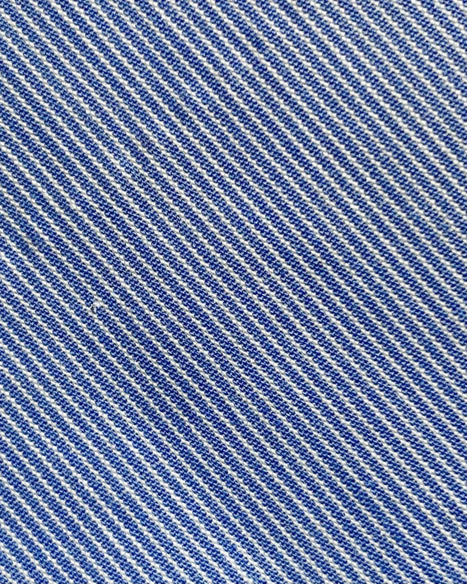 Close-up of blue and white striped denim fabric texture.