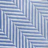 Blue and white herringbone fabric pattern creating geometric, angled lines for modern and stylish design.