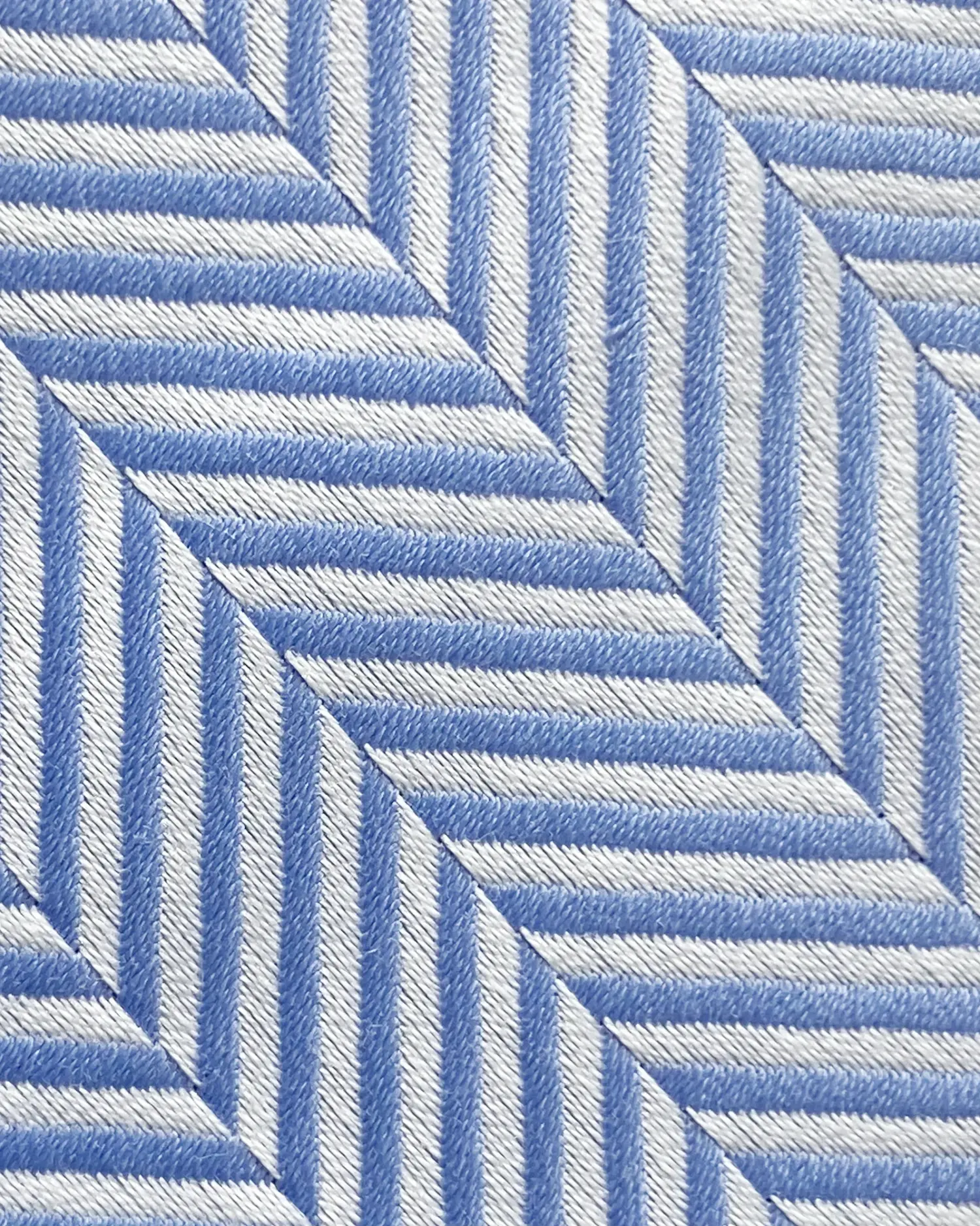 Blue and white herringbone fabric pattern creating geometric, angled lines for modern and stylish design.