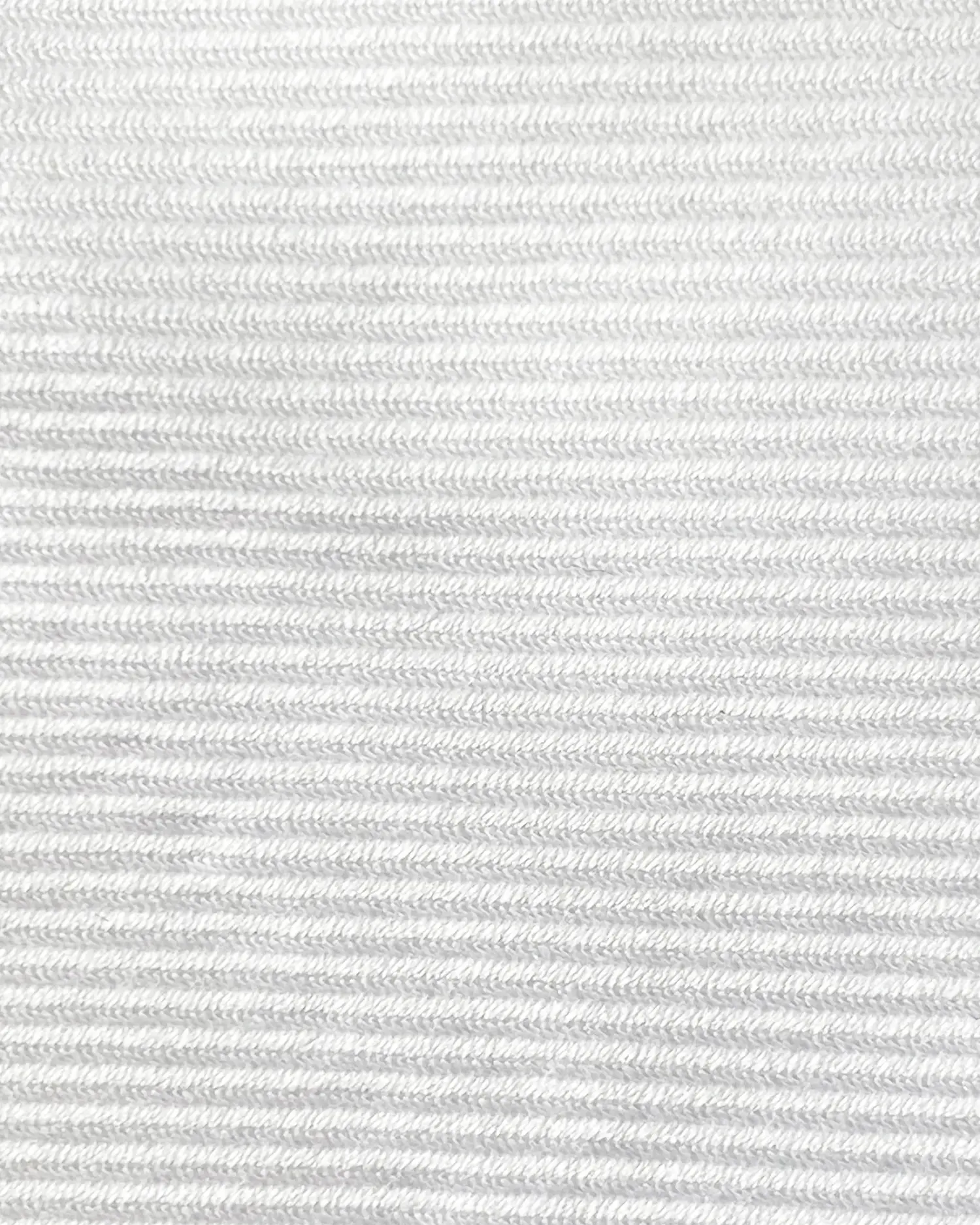 Close-up of white textured fabric with horizontal ribs and detailed stitching pattern.