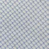 Close-up of blue and white houndstooth fabric pattern, showcasing intricate textile weave detail.