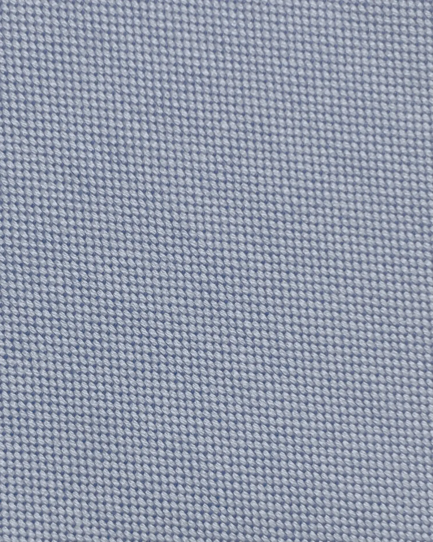 Close-up of blue woven fabric texture, revealing detailed weave pattern for textile backgrounds, design materials, or fashion.
