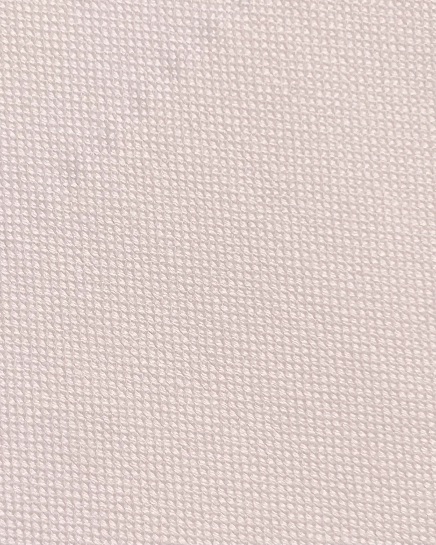 Close-up of textured white fabric, showcasing its detailed weave and pattern. Ideal for textiles and fashion projects.