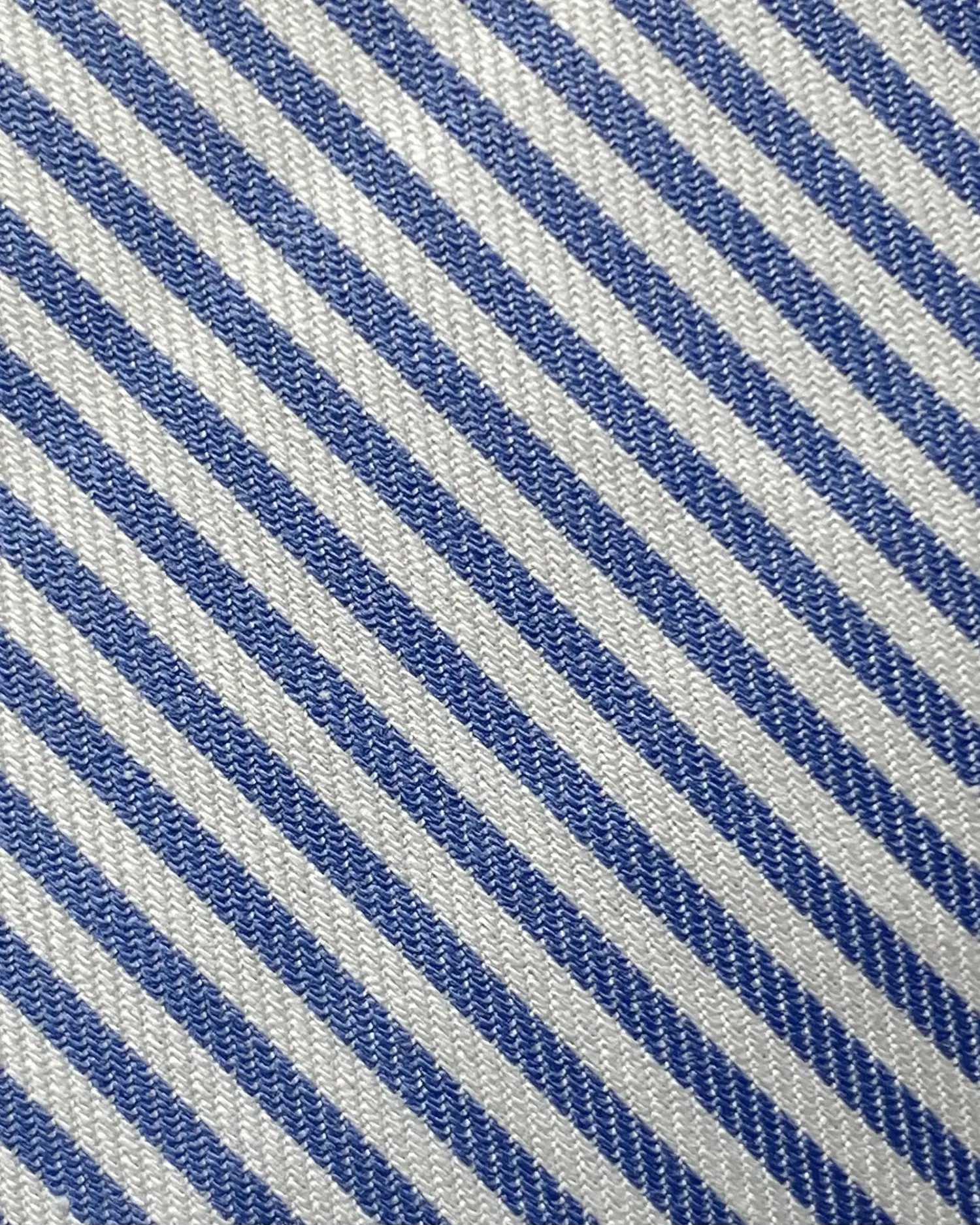 Close-up of blue and white diagonal striped fabric texture.