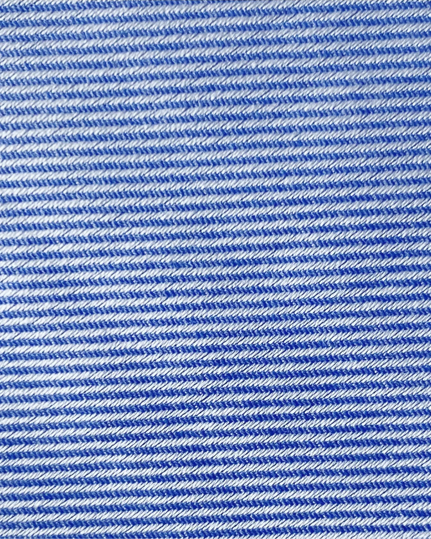 Close-up of blue and white striped denim texture, displaying woven pattern details.