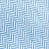 Close-up of blue and white herringbone fabric pattern with diagonal zigzag design.