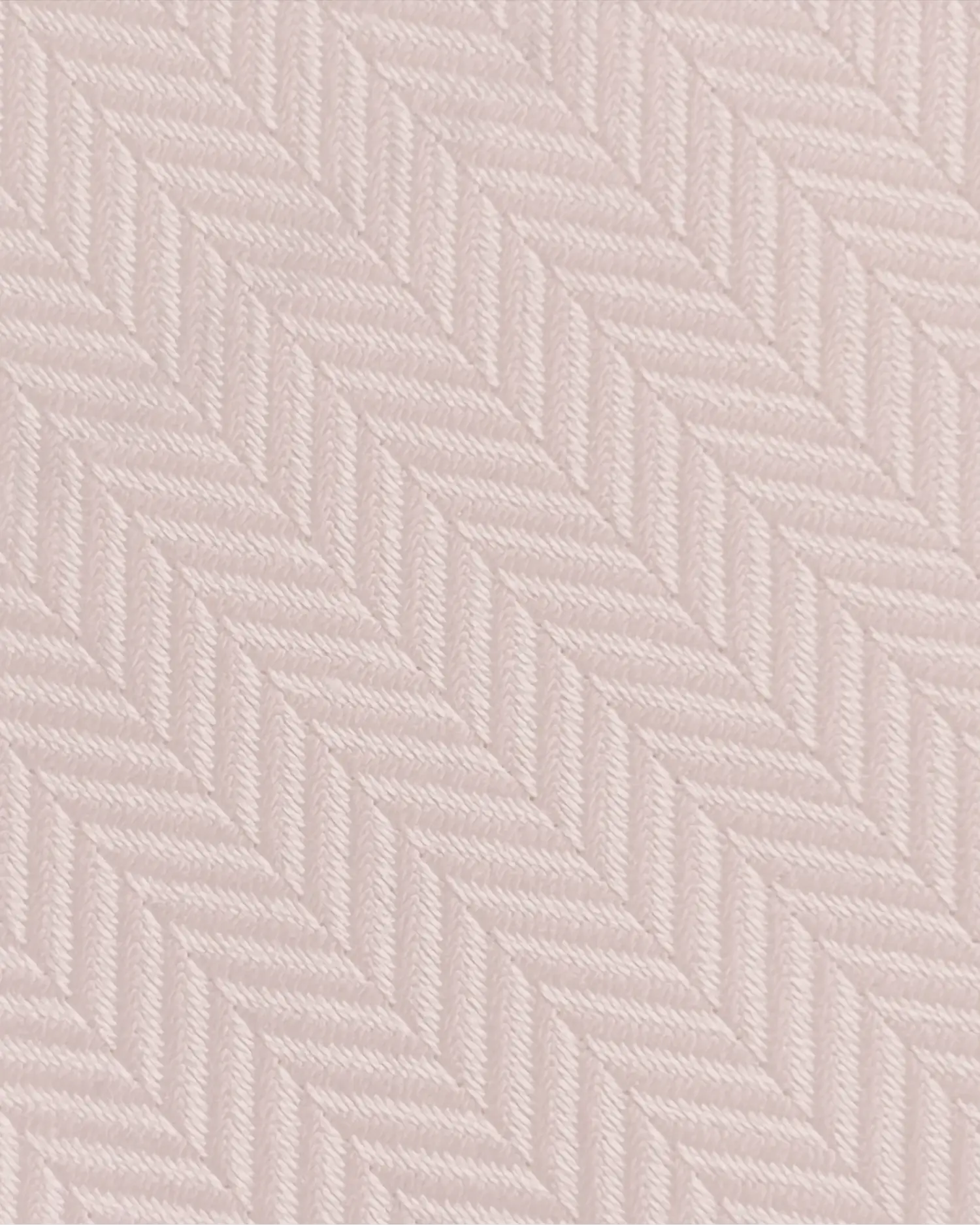 Close-up of a pink herringbone fabric pattern, showcasing detailed woven texture and diagonal lines.