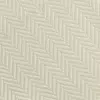 Close-up of a beige herringbone fabric texture, showcasing the intricate pattern and elegant design.