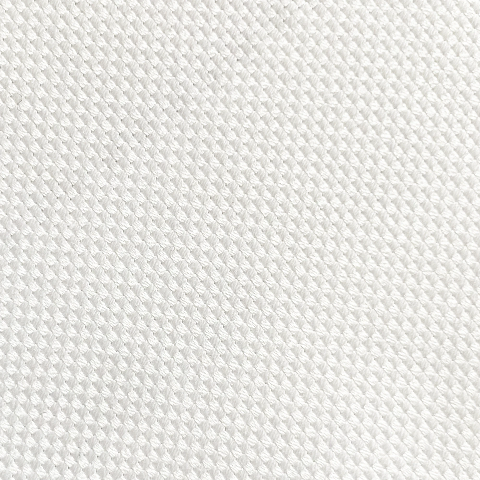 Close-up of a textured white fabric pattern, showcasing the intricate weave and durability of the material.