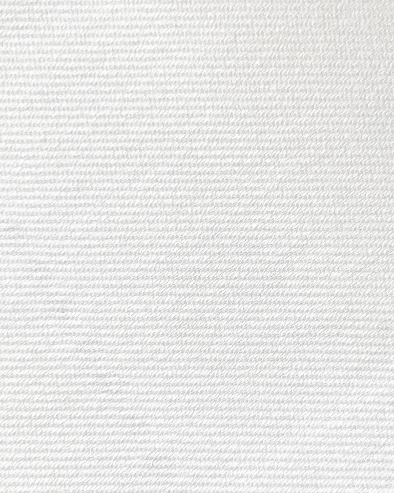 Close-up of white textured fabric, ideal for textile design and detail examination.