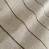 Close-up of beige fabric texture with wavy brown stripes.