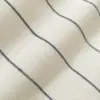 Close-up of beige fabric with blue stripes creating a minimalist pattern, enhancing texture and design elegance.