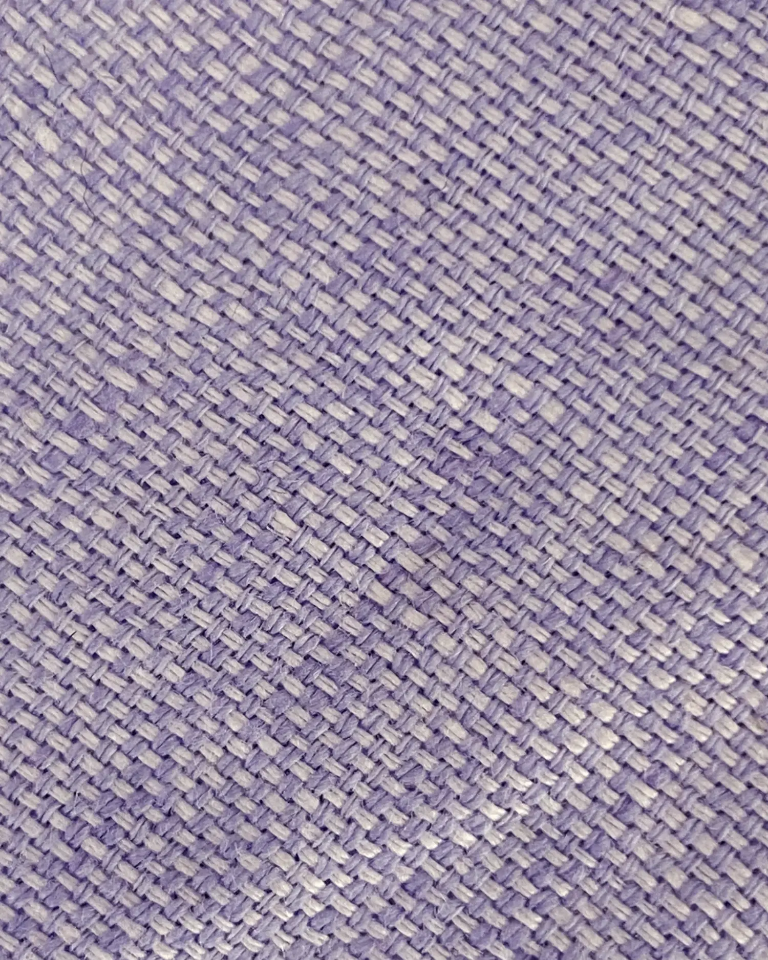 Close-up of purple woven fabric texture with a herringbone pattern.