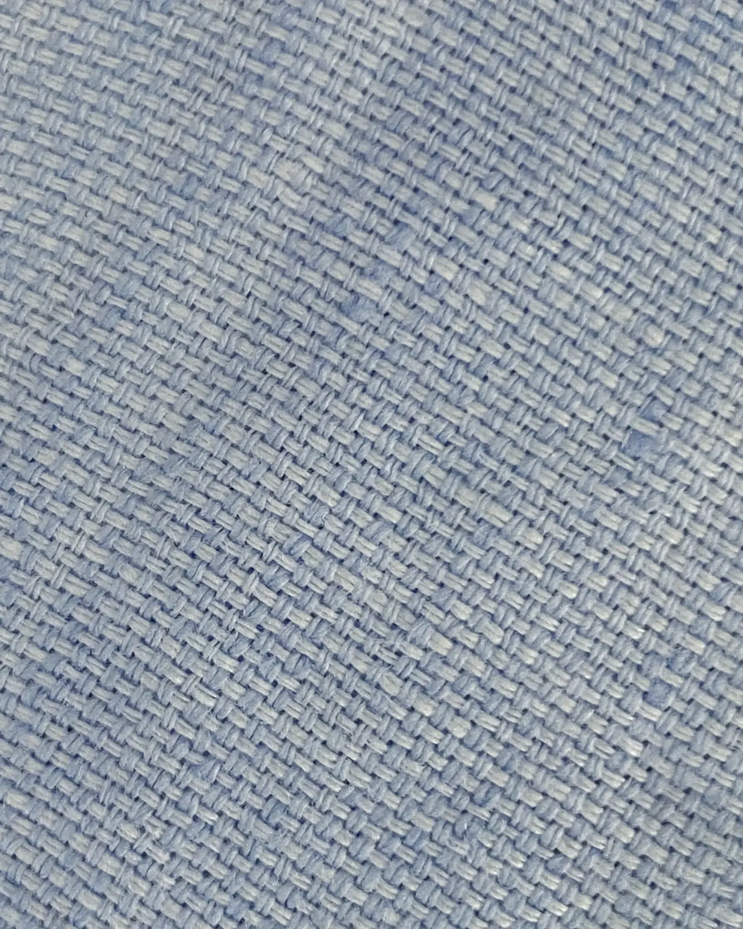 Close-up of blue textured fabric with a woven pattern. Ideal for textile, upholstery, or fashion design concepts.