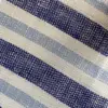 Close-up of blue and white striped woven fabric texture for fashion or interior design.