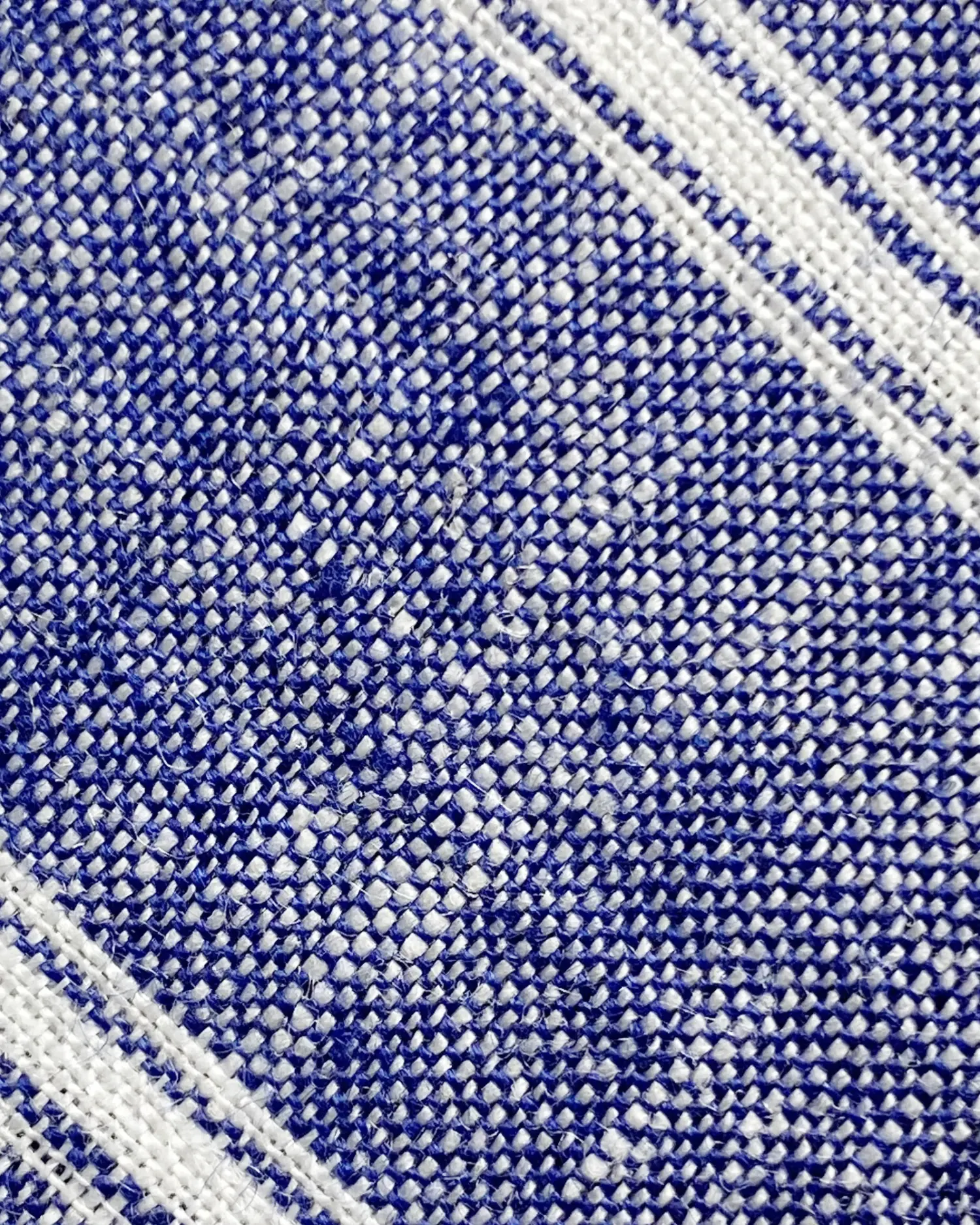 Close-up of blue and white woven fabric with diagonal stripe pattern.