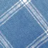 Close-up of a blue textured fabric with a white plaid pattern, showcasing intricate weaving details.