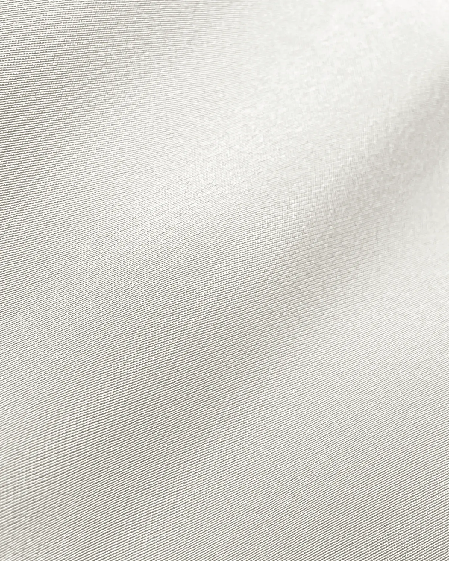 Closeup of smooth, white fabric texture, showing its fine weave pattern and soft sheen, ideal for textile and design content.