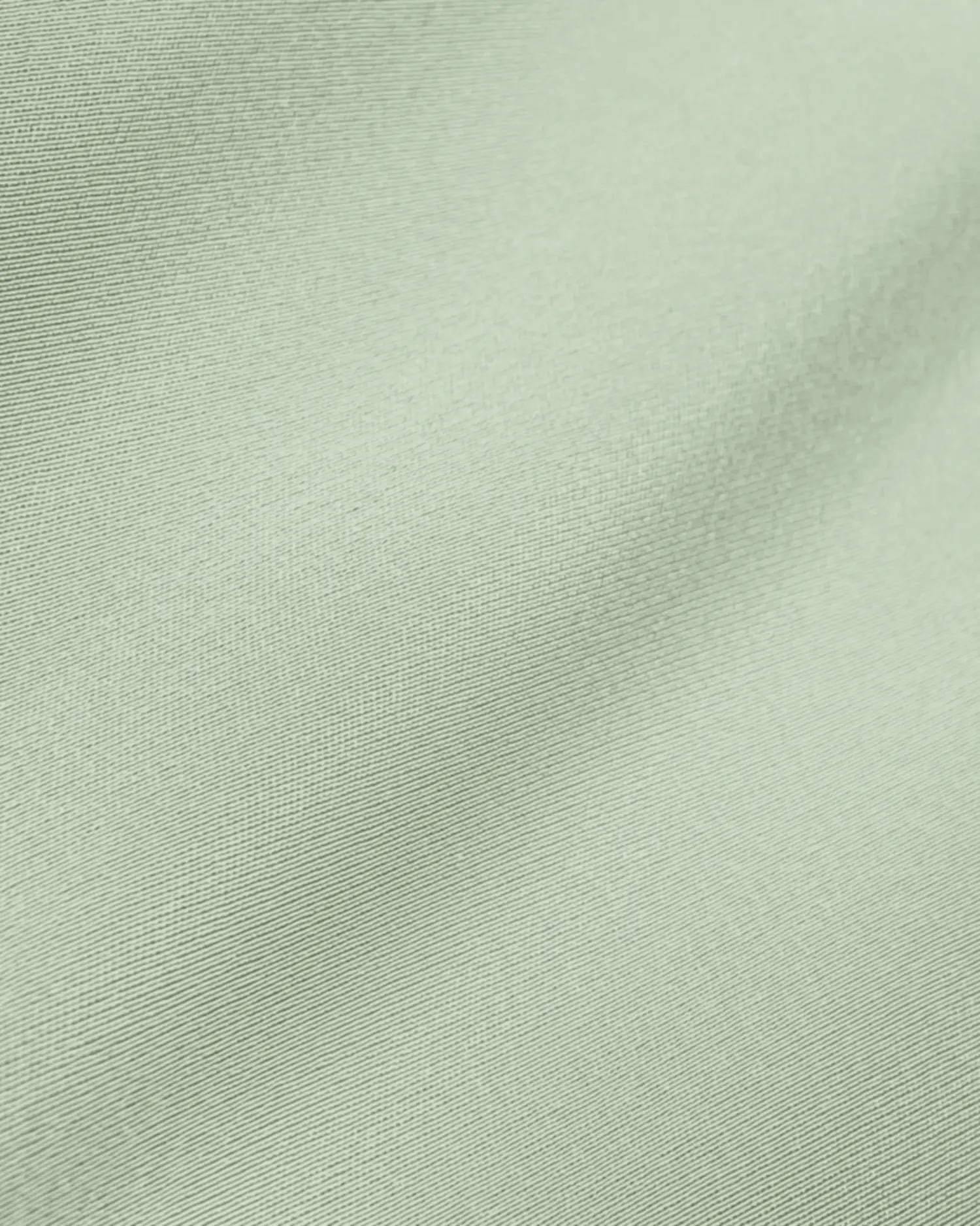 Smooth pale green fabric texture with subtle sheen, perfect for fashion and interior design inspiration.