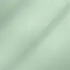 Close-up of light green fabric texture with subtle sheen and soft folds.