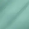Close-up of light blue-green fabric texture with subtle folds and detailed weave pattern.