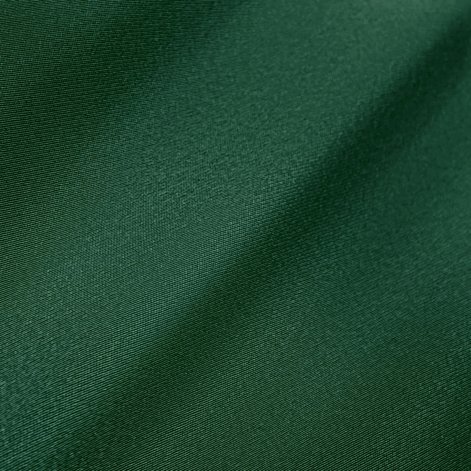 Smooth green fabric texture with soft, subtle folds and a silky sheen. Ideal for textiles and design inspiration.