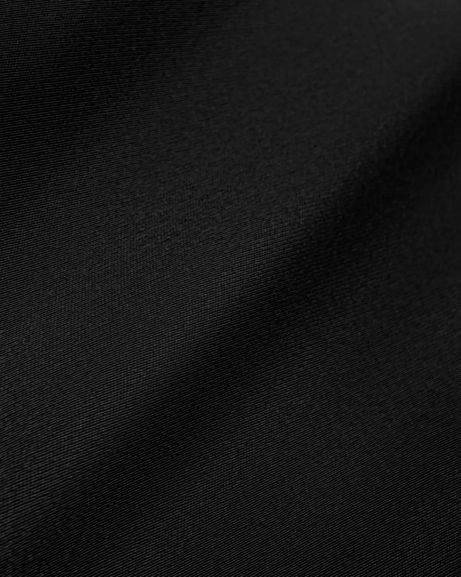Smooth black fabric texture with subtle folds, ideal for fashion, design, or background use.