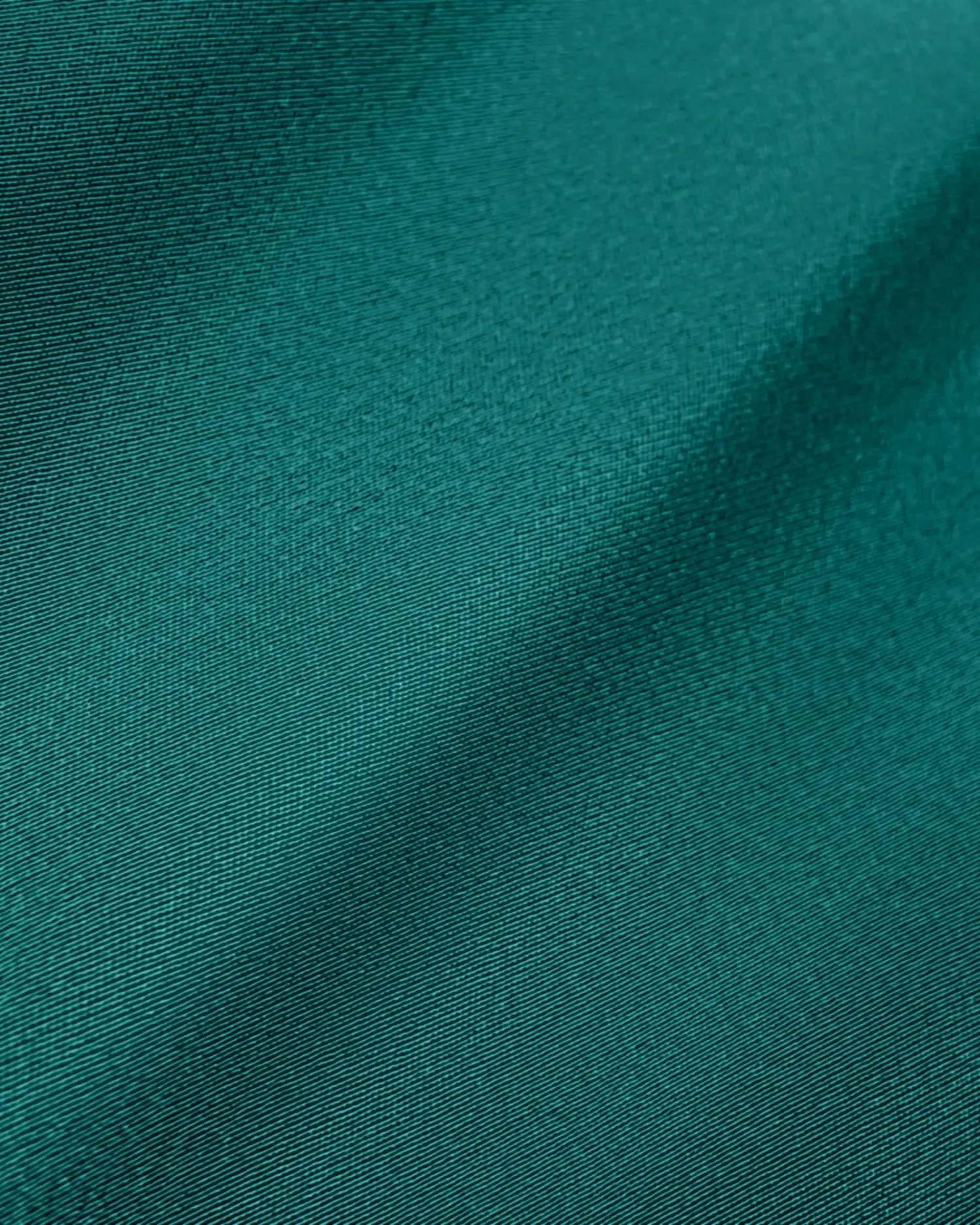 Close-up of green fabric texture with a soft sheen and smooth surface.