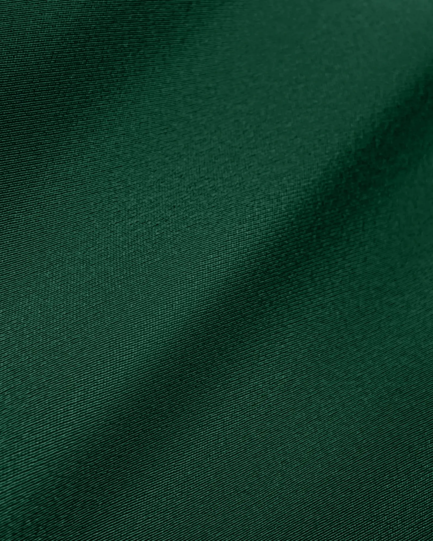 Close-up of smooth, dark green fabric texture, showcasing subtle folds and soft sheen. Ideal for fashion and textile design.