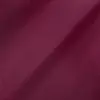 Close-up of smooth maroon fabric texture with subtle folds, ideal for textiles, design, and fashion backgrounds.