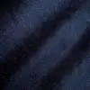 Close-up of dark blue textured fabric with light and shadow variations.